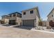 Charming two-story home with a gray garage door, desert landscaping, and a walkway gate at 15593 S 180Th Ln, Goodyear, AZ 85338