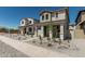 New construction home showcasing a charming two-story facade with a welcoming front porch at 15593 S 180Th Ln, Goodyear, AZ 85338