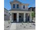 Charming two-story home featuring a covered front porch with stone accents and low-maintenance landscaping at 15593 S 180Th Ln, Goodyear, AZ 85338