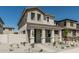 Charming two-story home featuring a welcoming front porch and low-maintenance desert landscaping at 15593 S 180Th Ln, Goodyear, AZ 85338