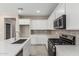 Close up of the kitchen showing gas cooktop, microwave and quartz countertops at 15593 S 180Th Ln, Goodyear, AZ 85338