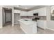 Bright kitchen features stainless steel appliances, white cabinets, and a center island at 15593 S 180Th Ln, Goodyear, AZ 85338