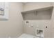Functional laundry room featuring shelf, washer hookups, and utility connections at 15593 S 180Th Ln, Goodyear, AZ 85338