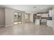 Open-concept living room and kitchen with neutral tones and access to the outdoors at 15593 S 180Th Ln, Goodyear, AZ 85338