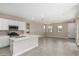 Open floor plan with kitchen, dining, and living area with bright windows and tile floors at 15593 S 180Th Ln, Goodyear, AZ 85338
