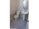Neat powder room featuring a modern pedestal sink, round mirror, and tiled floor at 15593 S 180Th Ln, Goodyear, AZ 85338
