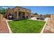 Wonderful backyard featuring a covered patio, lush green lawn, and sparkling pool at 157 N 110Th Ave, Avondale, AZ 85323