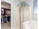 Bright bathroom featuring a glass-enclosed shower, walk-in closet, and a clean, modern design at 157 N 110Th Ave, Avondale, AZ 85323