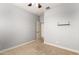 Carpeted bedroom with a ceiling fan, neutral walls, and trim at 157 N 110Th Ave, Avondale, AZ 85323