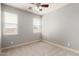 Well-lit, carpeted bedroom featuring two large windows at 157 N 110Th Ave, Avondale, AZ 85323