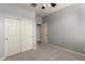 Bedroom with carpet, ceiling fan, sliding closet doors, and an additional door at 157 N 110Th Ave, Avondale, AZ 85323