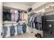 Organized walk-in closet with shelving, hanging rods, and a safe for storing valuables at 157 N 110Th Ave, Avondale, AZ 85323