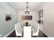 Elegant dining room featuring stylish decor, a modern chandelier, and seating for eight at 157 N 110Th Ave, Avondale, AZ 85323