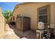 Exterior of the home featuring the A/C unit, a shed, a window, and the pool pump at 157 N 110Th Ave, Avondale, AZ 85323