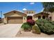 Charming single-Gathering home featuring desert landscaping, a two-car garage and a stucco exterior with a tile roof at 157 N 110Th Ave, Avondale, AZ 85323