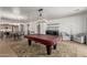 Open-concept space with a pool table, dining area, and seamless connection to a kitchen for easy entertaining at 157 N 110Th Ave, Avondale, AZ 85323