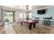 Entertaining game room with pool table, stylish bar stools, and easy access to the outdoor patio at 157 N 110Th Ave, Avondale, AZ 85323