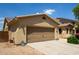 Charming single-Gathering home featuring desert landscaping, a two-car garage and a stucco exterior with a tile roof at 157 N 110Th Ave, Avondale, AZ 85323