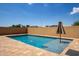 Private backyard pool with tiled surround and privacy wall is perfect for hot summer days at 157 N 110Th Ave, Avondale, AZ 85323