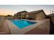 Private backyard oasis with a sparkling pool, tanning deck, and a comfortable seating area at 157 N 110Th Ave, Avondale, AZ 85323