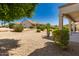 Low maintenance backyard featuring desert landscaping and a covered patio, perfect for outdoor living at 16066 W Sandia Park Dr, Surprise, AZ 85374