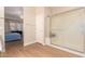 Bathroom with a glass door shower and access to the spacious bedroom at 16066 W Sandia Park Dr, Surprise, AZ 85374