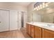 Well-lit bathroom featuring a double sink vanity and a sliding glass door shower at 16066 W Sandia Park Dr, Surprise, AZ 85374