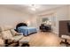 Bright bedroom featuring a comfortable lounge chair, desk and a ceiling fan at 16066 W Sandia Park Dr, Surprise, AZ 85374
