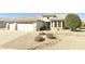 A serene property featuring manicured landscaping, desert rock, and a charming single-story home at 16066 W Sandia Park Dr, Surprise, AZ 85374
