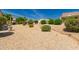 Front yard features lush desert landscaping, rocks and gravel for easy maintenance at 16066 W Sandia Park Dr, Surprise, AZ 85374