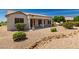 Beautiful desert landscaping complements the exterior of this well maintained home at 16066 W Sandia Park Dr, Surprise, AZ 85374