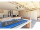 Spacious garage offering ample storage cabinets with room for parking and a shuffle board setup at 16066 W Sandia Park Dr, Surprise, AZ 85374
