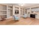 Inviting living room featuring a built-in shelving unit and cozy seating, perfect for relaxation at 16066 W Sandia Park Dr, Surprise, AZ 85374
