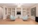 Living room showcasing a built-in entertainment center and large window offering ample natural light at 16066 W Sandia Park Dr, Surprise, AZ 85374