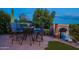 Backyard patio with blue cushioned outdoor seating and manicured green space at 1617 E Copper Holw, Queen Creek, AZ 85140