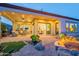 Backyard with stone patio, fire pit, and covered outdoor living and dining spaces at 1617 E Copper Holw, Queen Creek, AZ 85140