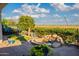 Lush backyard with a seating area, a built-in fire feature, mature landscaping, and desert views at 1617 E Copper Holw, Queen Creek, AZ 85140