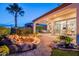 Landscaped backyard with a rock fire pit, patio, and palm tree, creating an inviting outdoor living space at 1617 E Copper Holw, Queen Creek, AZ 85140