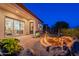 Inviting backyard featuring a fire pit, patio area, and sliding glass doors, creating a seamless indoor-outdoor living experience at 1617 E Copper Holw, Queen Creek, AZ 85140