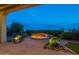 A paver patio features a built-in fire pit, decorative planters and desert views at 1617 E Copper Holw, Queen Creek, AZ 85140