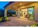 Elegant backyard with stone patio featuring both covered and open living spaces at 1617 E Copper Holw, Queen Creek, AZ 85140