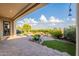 Landscaped backyard oasis with stone patio and artificial turf, providing a private and inviting outdoor space for relaxation at 1617 E Copper Holw, Queen Creek, AZ 85140