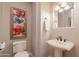 Charming half bathroom with decorative art and stylish pedestal sink at 1617 E Copper Holw, Queen Creek, AZ 85140