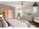 Bright bedroom featuring a ceiling fan, shuttered windows, and stylish decor at 1617 E Copper Holw, Queen Creek, AZ 85140