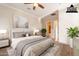 Staged bedroom with a large bed, bedside table, and an ensuite bathroom at 1617 E Copper Holw, Queen Creek, AZ 85140