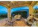 Relaxing covered patio with comfortable seating and views of the yard at 1617 E Copper Holw, Queen Creek, AZ 85140