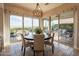 Bright dining area features a round table, chairs, and large windows offering beautiful outdoor views at 1617 E Copper Holw, Queen Creek, AZ 85140