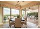Chic dining room with modern lighting and sliding glass doors to the patio area at 1617 E Copper Holw, Queen Creek, AZ 85140
