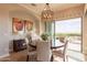 Elegant dining room with a round table, chandelier, and sliding glass doors to the outside at 1617 E Copper Holw, Queen Creek, AZ 85140