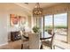 Elegant dining area with a round table and large windows offering scenic views at 1617 E Copper Holw, Queen Creek, AZ 85140
